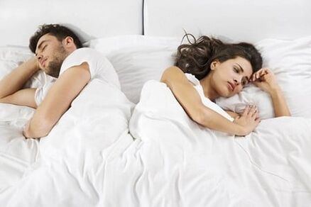 A man with weak potency and a frustrated woman in bed